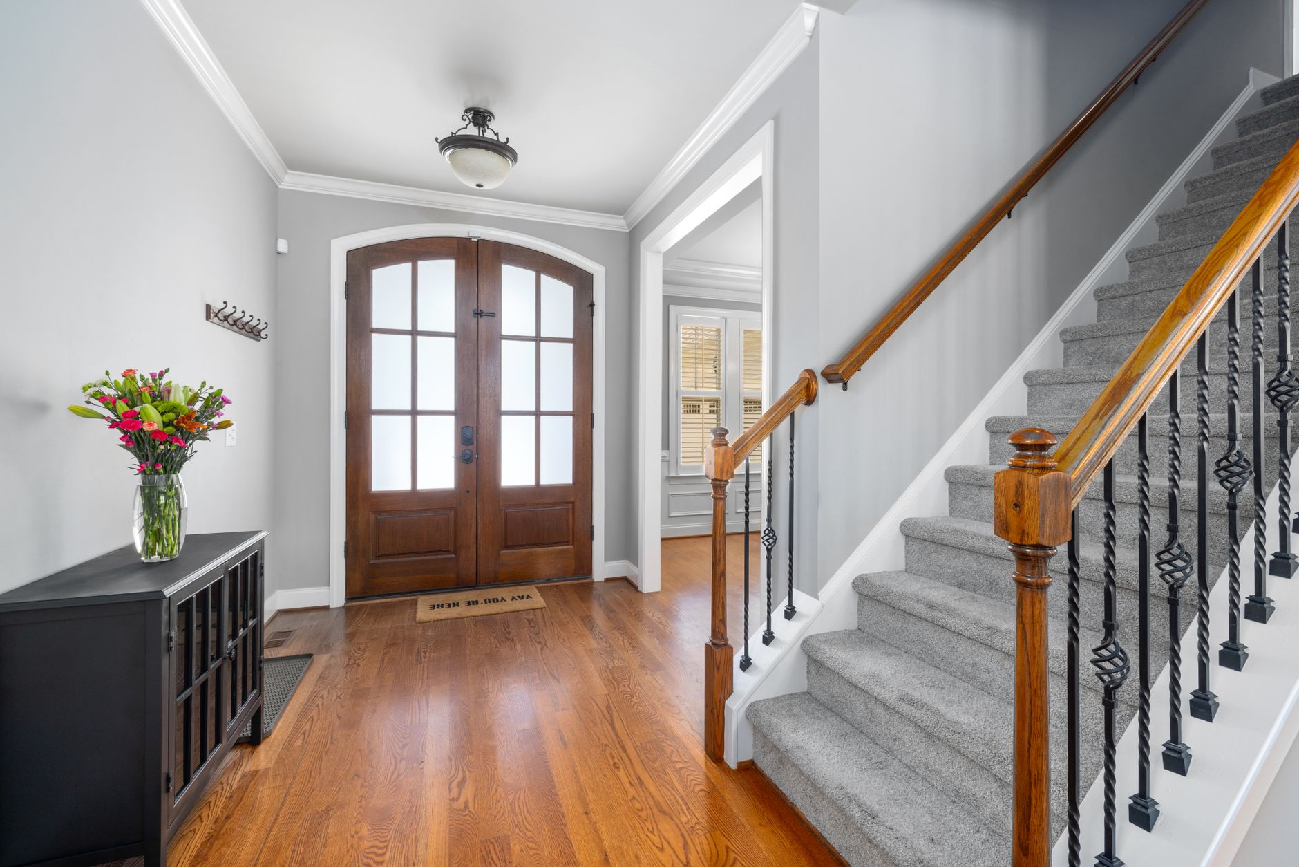 Foyer — Restored oak millwork and leaded glass, lit properly for the first time in decades.