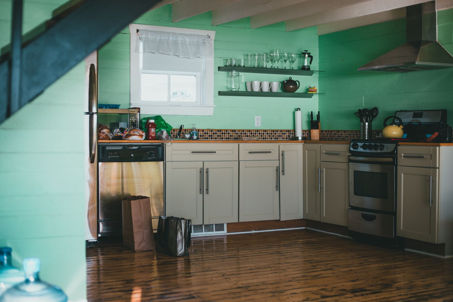 Kitchen — New cabinetry that speaks craftsman without costume; soapstone and brass.